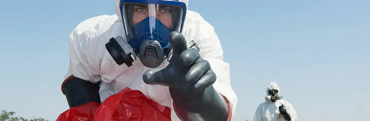 sewage clean up technician wearing protective gear handling biohazard materials in Miami, FL