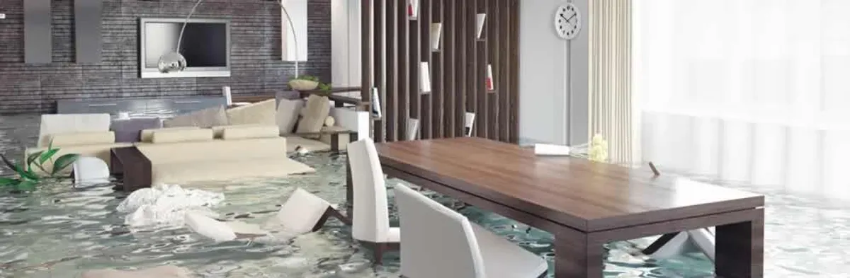 home interior affected by water damage with flooded floors and displaced furniture in Miami, FL